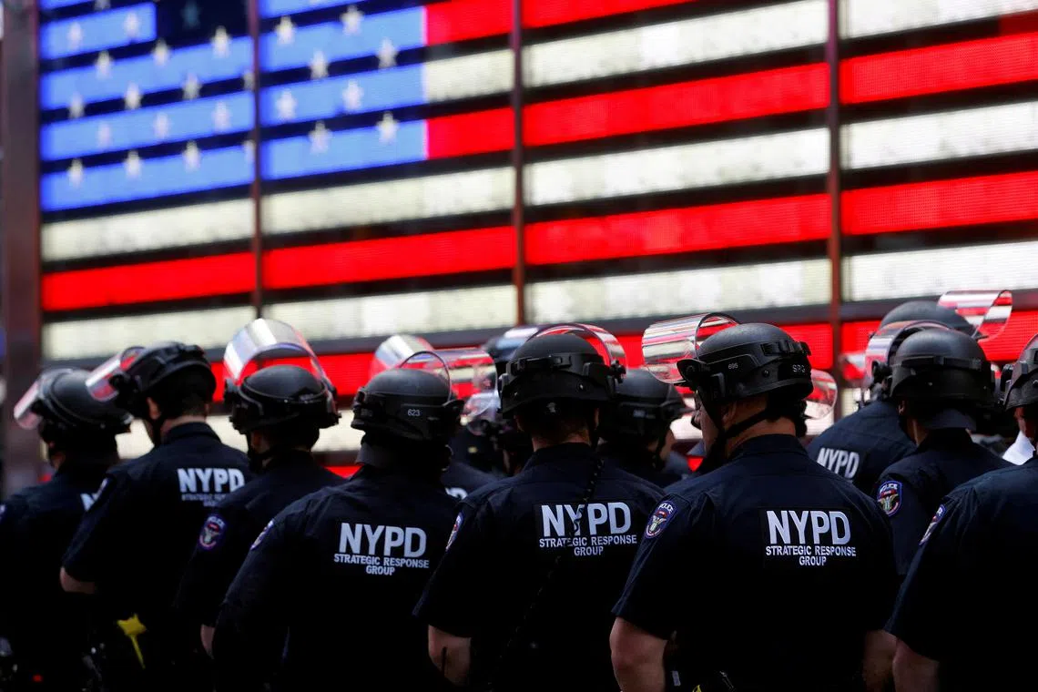 FILE PHOTO: New York Police Department (NYPD) officers are pictured as protesters rally against the death in Minneapolis police custody of George Floyd, in Times Square in the Manhattan borough of New York City, U.S., June 1, 2020. REUTERS/Mike Segar/File Photo