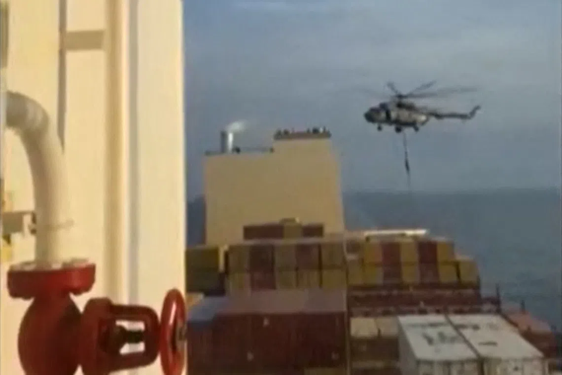 An Iranian Guards helicopter reportedly boarded and took the cargo ship into Iranian waters.