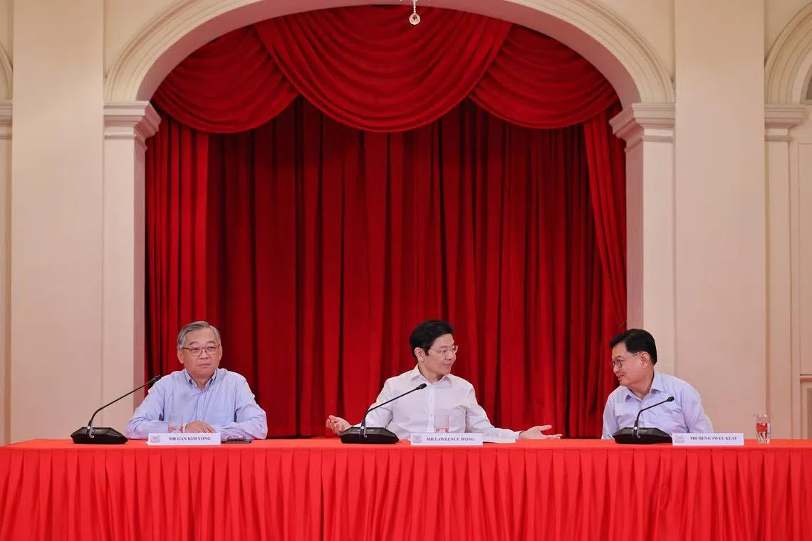 (From left) Minister for Trade and Industry Gan Kim Yong, DPM Lawrence Wong and DPM Heng Swee Keat at a press conference announcing the new Cabinet line-up on May 13.