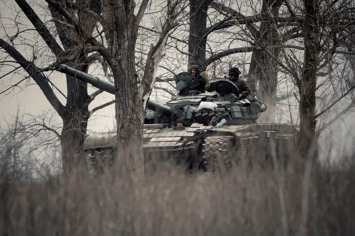 Ukrainian service members ride a tank, as Russia's attack on Ukraine continues, in Donbas region, Ukraine April 8, 2023. REUTERS/Yan Dorbronosov