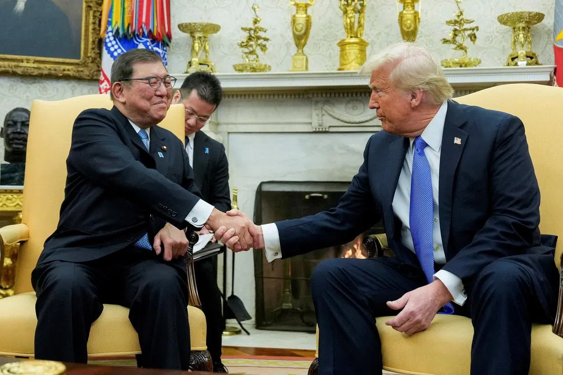 FILE PHOTO: U.S. President Donald Trump shakes hands with Japan's Prime Minister Shigeru Ishiba at the White House in Washington, U.S., February 7, 2025. REUTERS/Kent Nishimura/File Photo