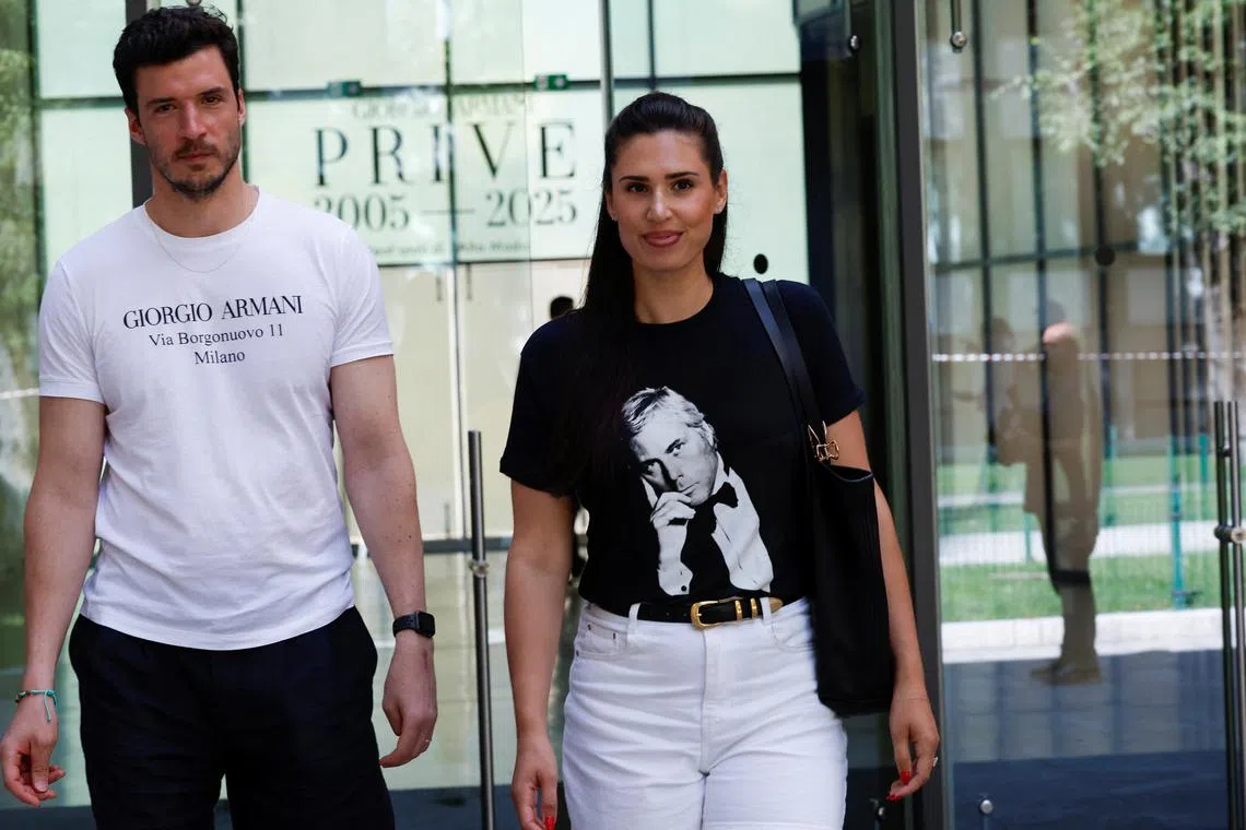 People wearing Armani T-shirts walking at the Armani/Silos exhibition space in Milan on Sept 5 after the death of Giorgio Armani.