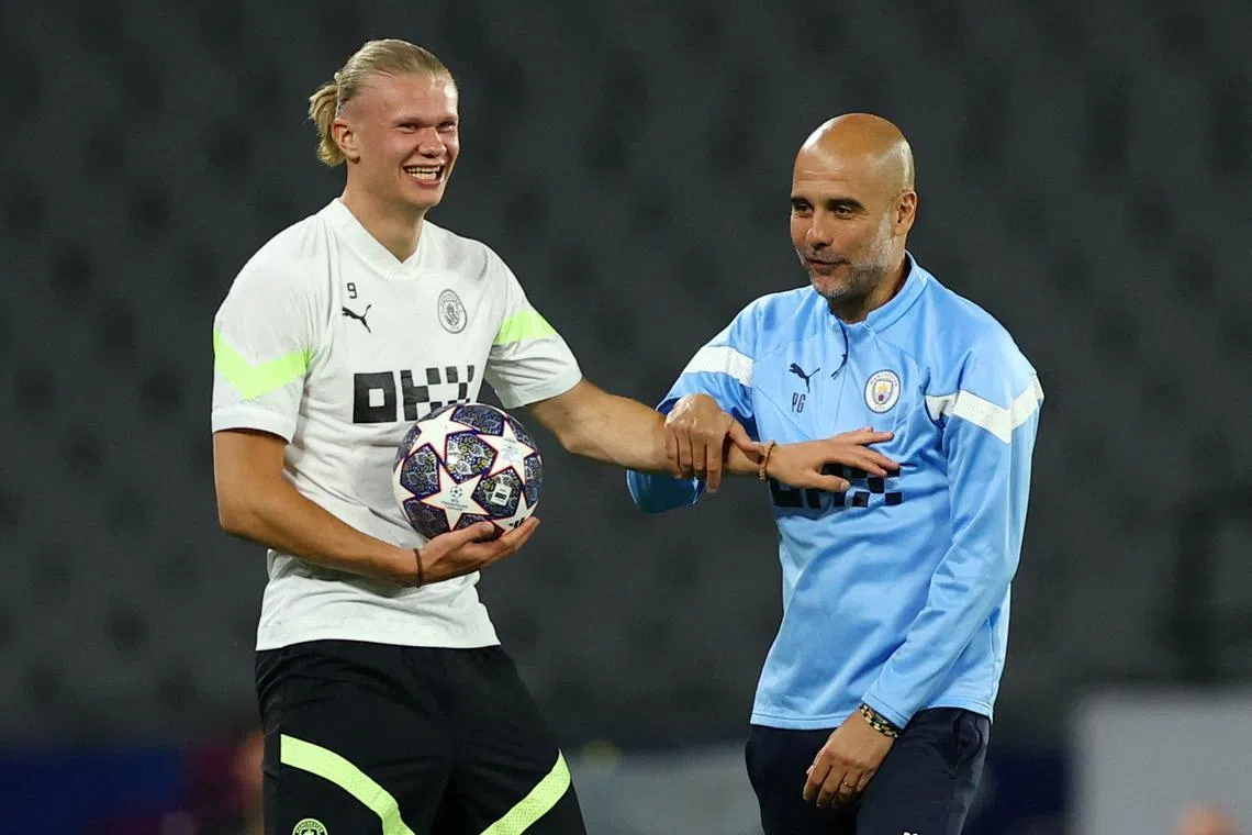 Manchester City manager Pep Guardiola with Erling Braut Haaland during training.