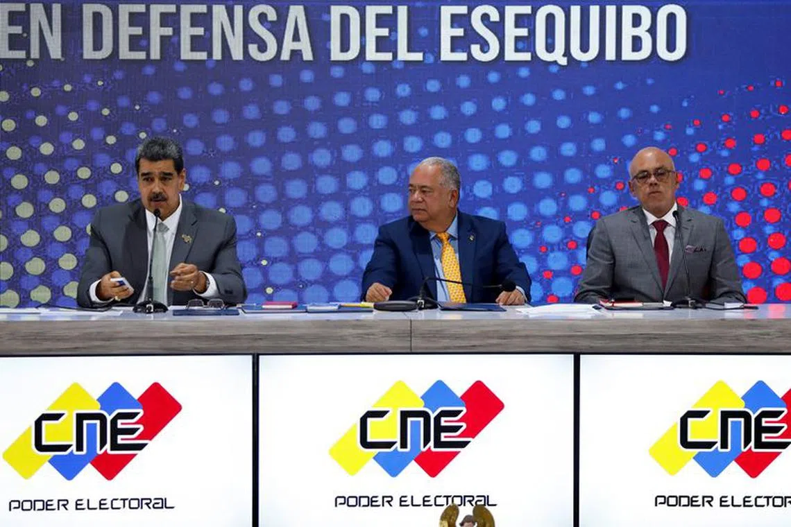 Venezuelan President Nicolas Maduro, Venezuelan National Assembly's President Jorge Rodriguez and Elvis Hidrobo Amoroso, head of Venezuela's National Electoral Council (CNE), attend an event at the National Electoral Council (CNE) after voters in a referendum rejected the International Court of Justice's (ICJ) jurisdiction over the country's territorial dispute with Guyana and backed the creation of a new state in the potential oil-rich Esequibo, in Caracas, Venezuela, December 4, 2023. REUTERS/Leonardo Fernandez Viloria