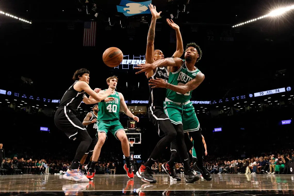 Marcus Smart of the Boston Celtics passes against Nic Claxton of the Brooklyn Nets during their game at Barclays Centre.