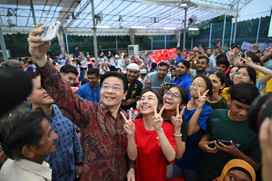 PM Lawrence Wong taking a wefie with youths at the Iftar Utara 2025 - Break of Fast @ Marsiling at Marsiling Mega Sports Park on March 16.