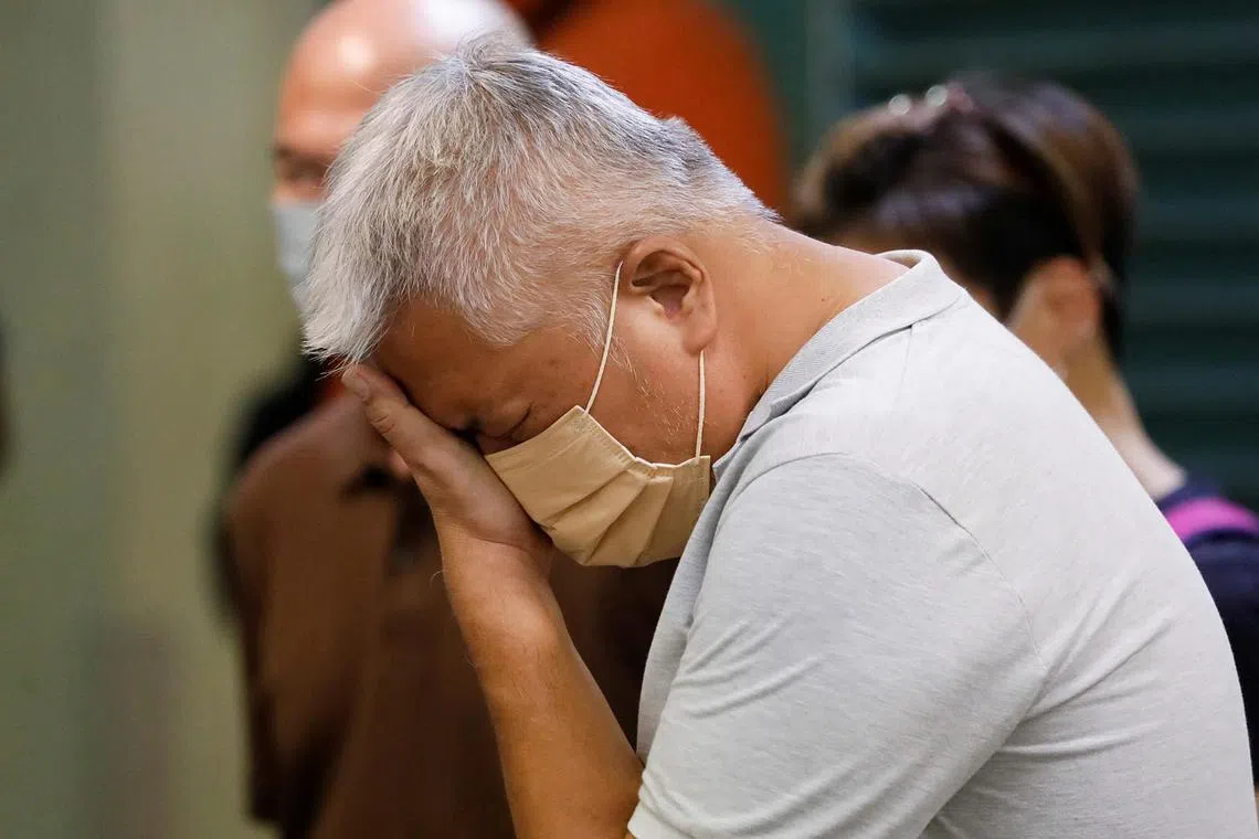 A relative of one of the victims wiping his tears at Sungai Buloh Hospital's mortuary in Sungai Buloh, Selangor, on Dec 17, 2022. 