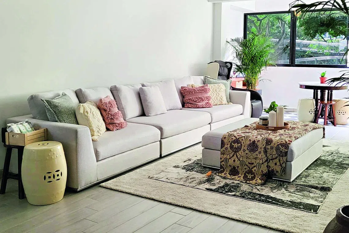 The living room's new light wood-look tiles were chosen for their durability and longevity. The dark wood console and ceramics add flair.