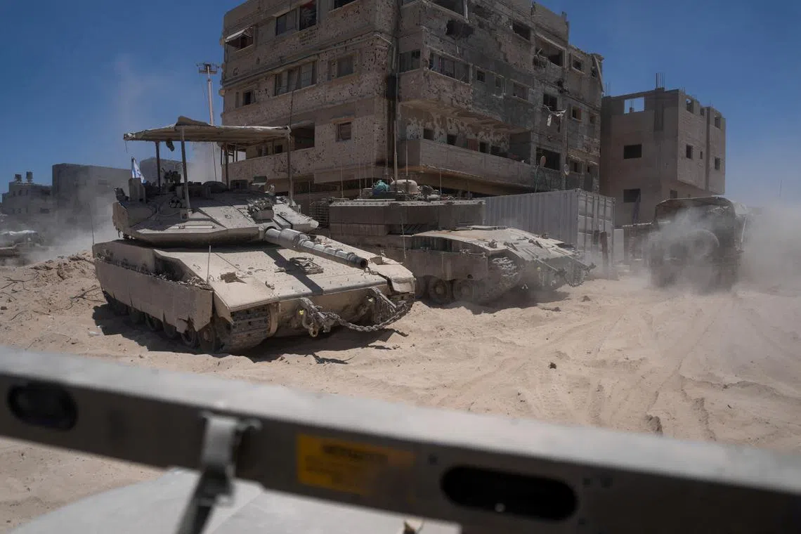 FILE PHOTO: Israeli tanks operate next to destroyed buildings during a ground operation in the southern Gaza Strip, July 3, 2024. Ohad Zwigenberg/Pool via REUTERS/File Photo