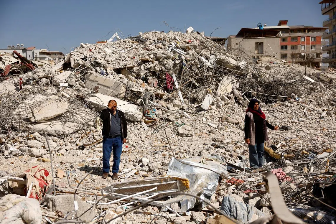 FILE PHOTO: Hasan Arslan, and his wife Havva visit what's left of their home, where they were trapped with his three children for five days until being rescued, in the aftermath of a deadly earthquake in Nurdagi, Turkey, March 4, 2023. REUTERS/Susana Vera/File Photo