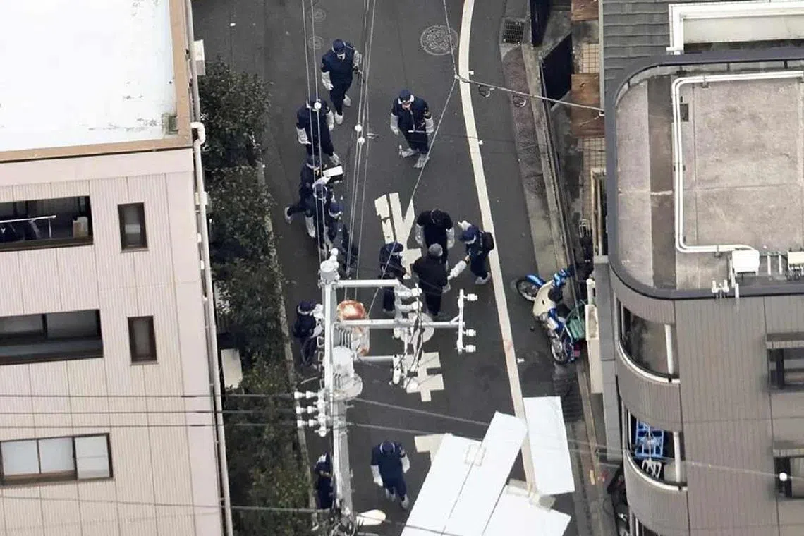 Police officers investigating the scene where a woman was stabbed near JR Takadanobaba Station at 11.16am on March 11, 2025.