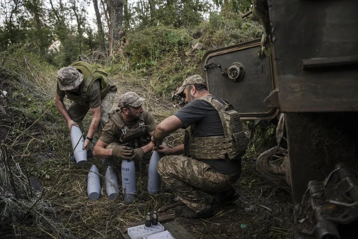 Ukrainian soldiers with a resupply of artillery for their howitzer, in the Bakhmut region of Ukraine.