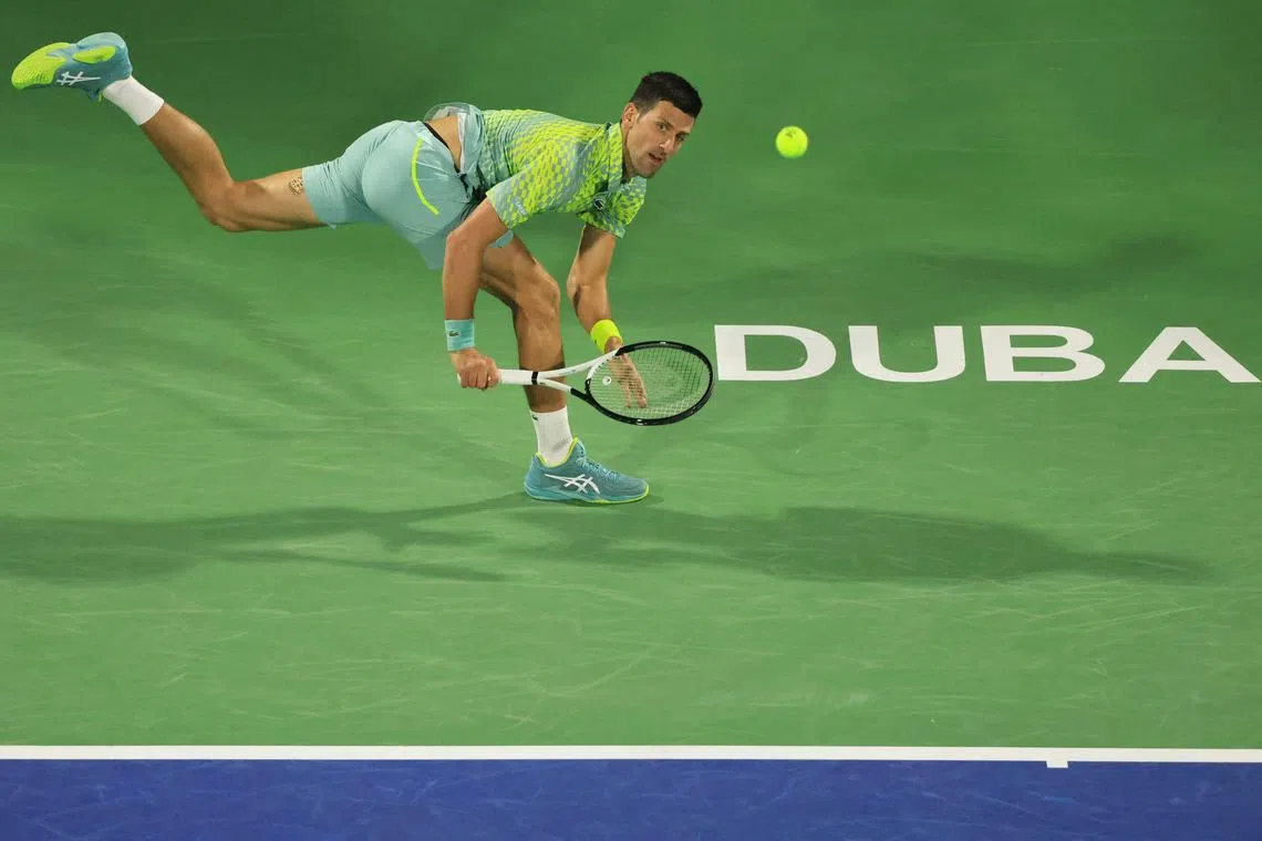 Novak Djokovic hits a return against Russia's Daniil Medvedev during their ATP Dubai Duty Free Tennis Championship semi-final match on March 3, 2023.