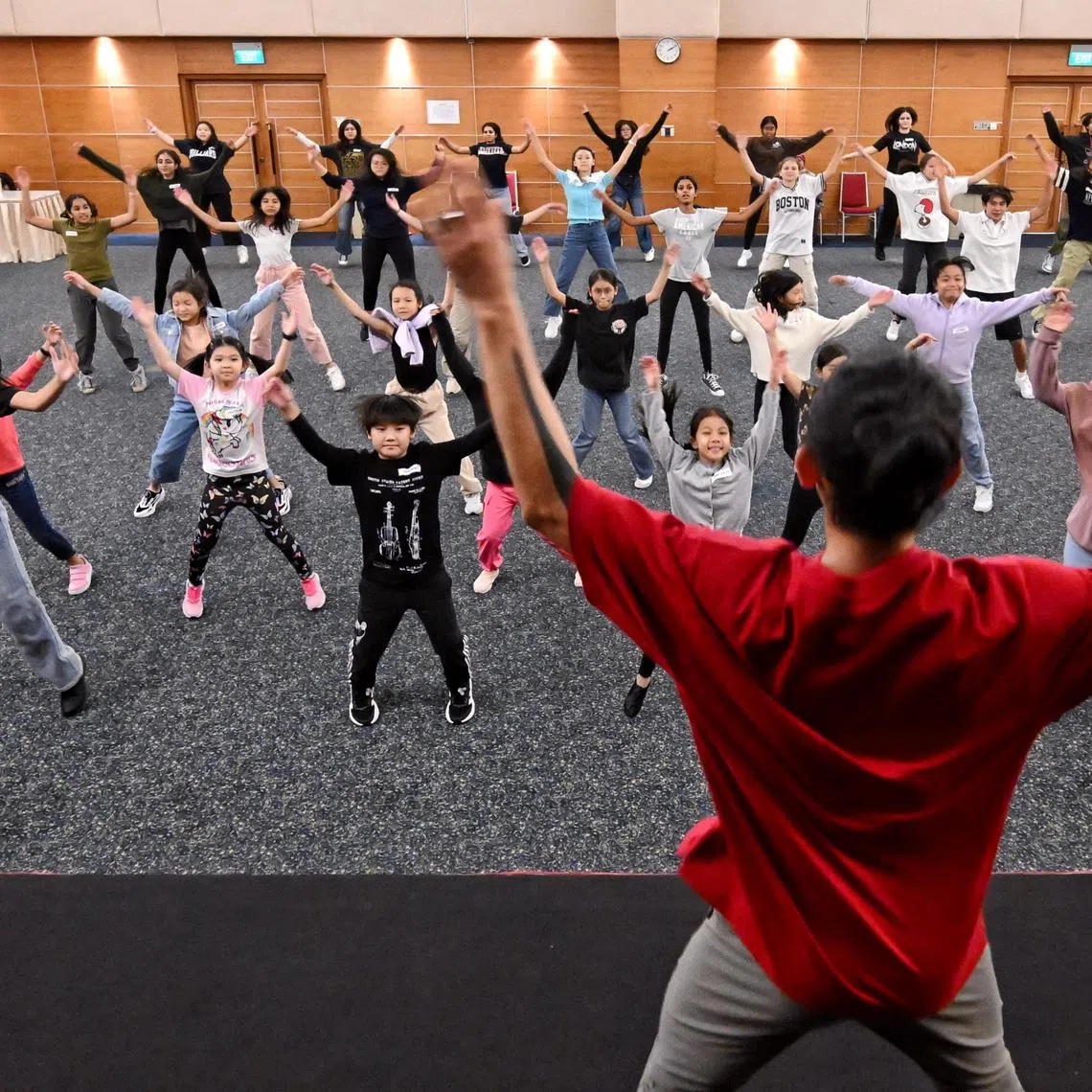 ST20240903_202443200605 Kua Chee Siong/ edchildaid/
Front row from L to R: Kaylen Thawdar Hnin Htet, 15 years old, Travis Wong Kai Xuan, 9 years old, Jemima Liew-Yeo, 10 years old, Husna Humaira Bte Muhamad Hairie, 15 years old and Hafeez Hav Hassan, Chief Choreographer, at the three-day workshop for ChildAid 2024 The Dream Emporium.
The young talents who will be performing at ChildAid 2024 will take part in workshops held at the SPH Auditorium. The 20th edition of the charity concert organised by The Straits Times (ST) and The Business Times will take place at the Esplanade Theatre on Nov 29 and 30.