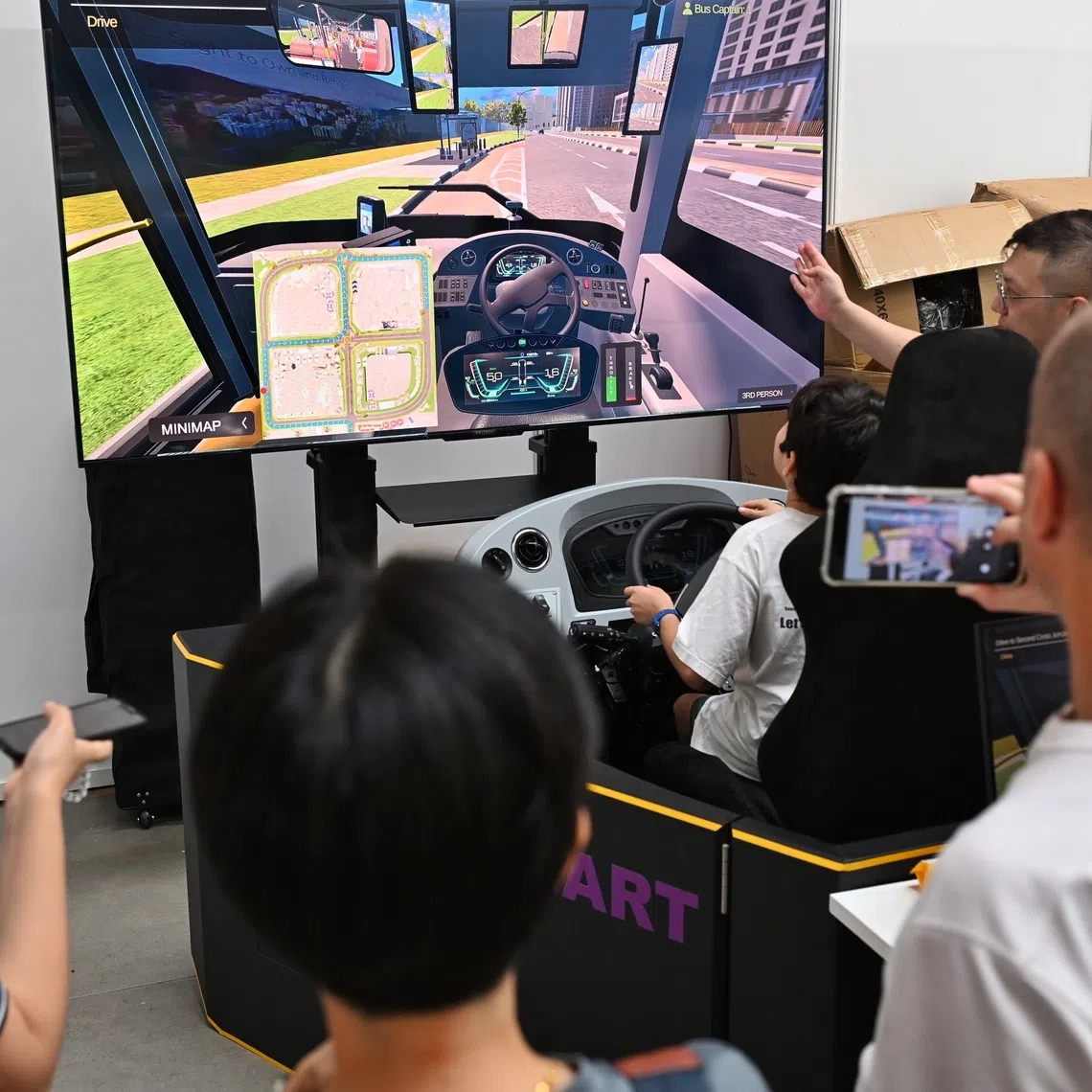 Visitors at the SBST driving simulator booth at the LTA Annual Public Safety & Security Awards and Bus Safety Roadshow on Aug 21.