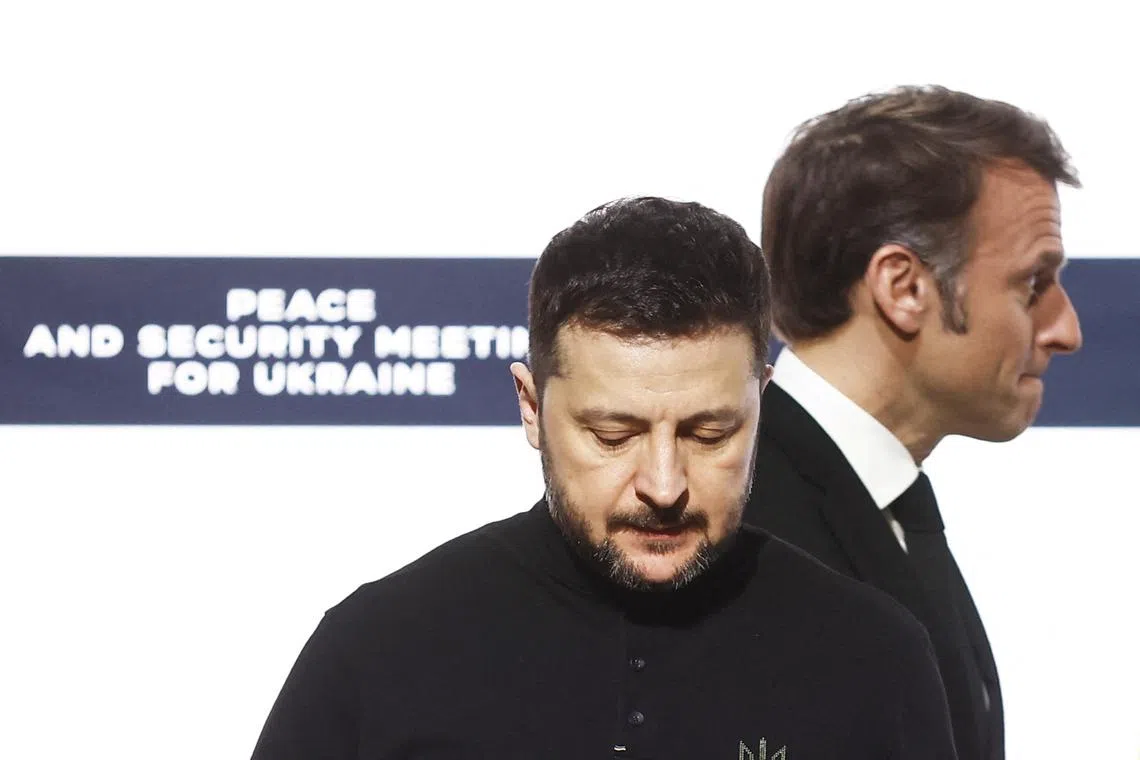 French President Emmanuel Macron and Ukrainian President Volodymyr Zelenskiy at the end of the press conference following a bilateral meeting at the Elysee Palace in Paris, France, March 26, 2025. YOAN VALAT/Pool via REUTERS