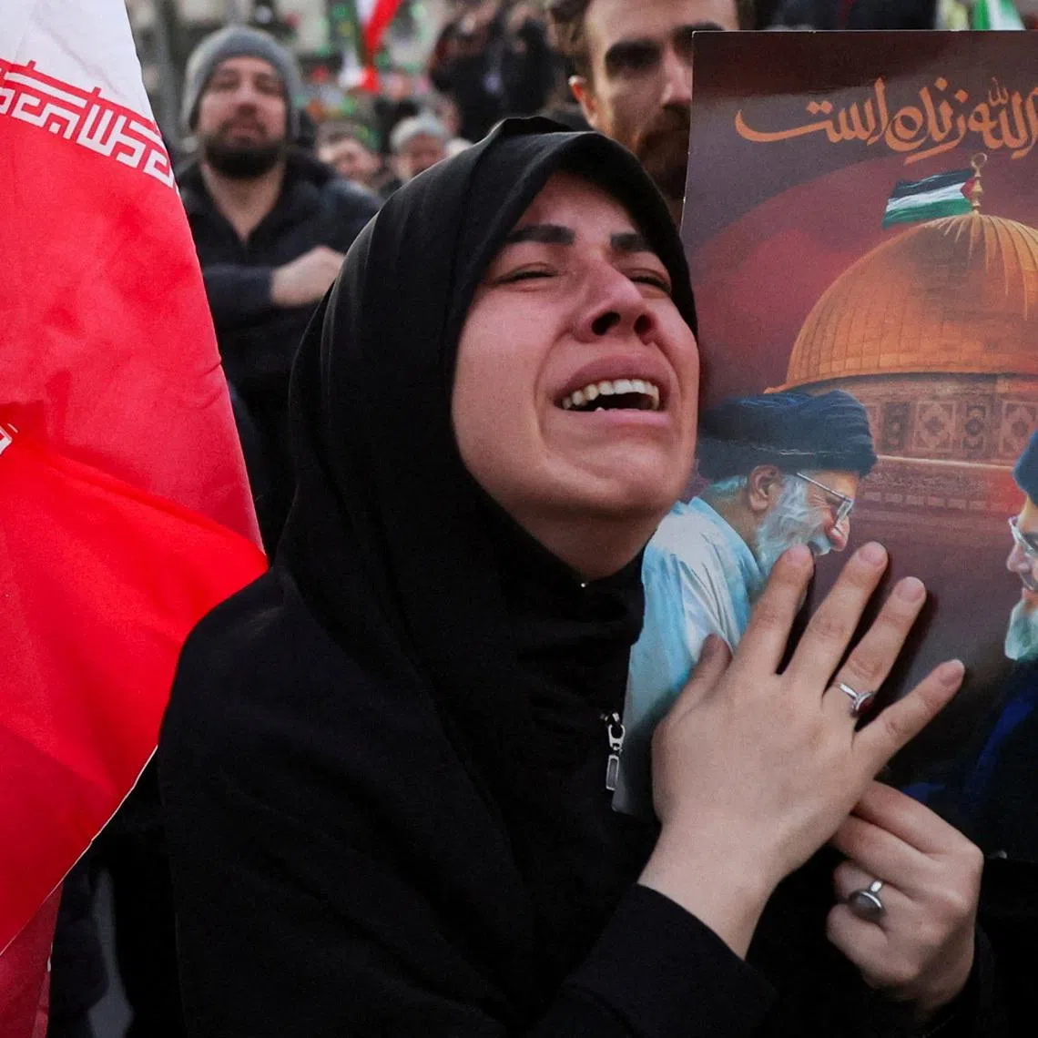 A woman reacts as people gather at the Enghelab Square, after Iran's Supreme Leader Ayatollah Ali Khamenei was killed in Israeli and U.S. strikes on Saturday, in Tehran, Iran, March 1, 2026. Majid Asgaripour/WANA (West Asia News Agency) via REUTERS