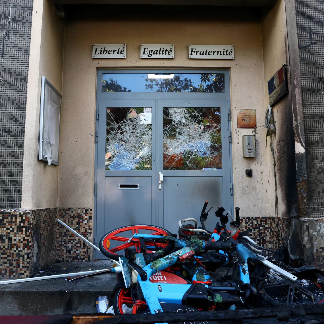 FILE PHOTO: View of the damaged entrance doors of the Lycee Vauquelin high school with bicycles and garbage bins set on fire by protesters in Paris as high school students continue protests in France voicing anger over overcrowded classrooms, teacher shortages and dilapidated school buildings, which students blame on years of underinvestment, continue, France, October 5, 2026. REUTERS/Yves Herman/File Photo