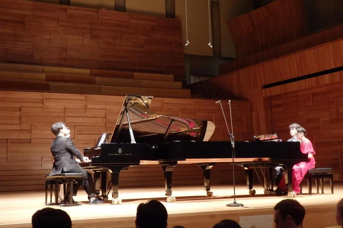 Four pianists perform Bertram Wee’s arrangement of Kelly Tang’s Symphonic Suite On A Set Of Local Tunes on two pianos as part of Piano Extravaganza 2024 