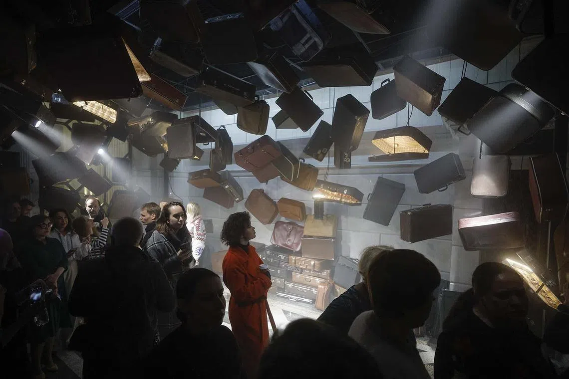 Visitors walking past an installation at 'The Star Is Rising' interactive Christmas exhibition at the Central Railway Station in Kyiv, Ukraine, Dec 21, 2023.