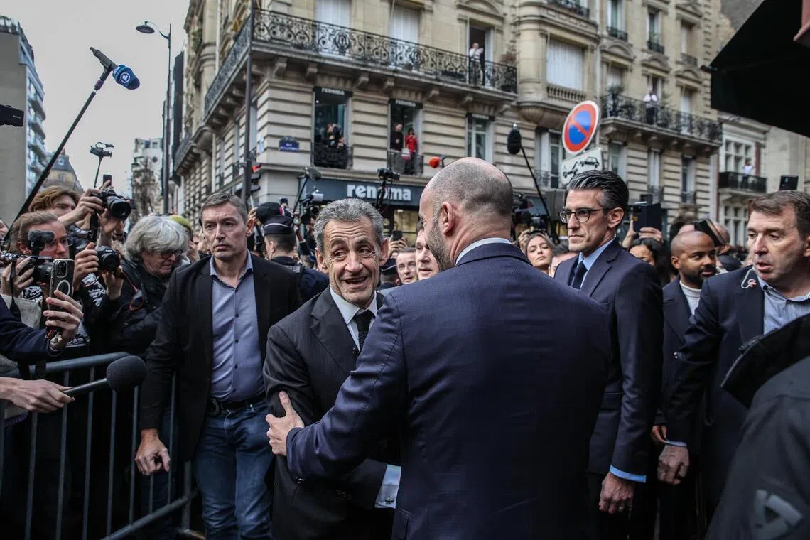 Former French president Nicolas Sarkozy arrives to sign copies of his book at the Lamartine bookshop in Paris.