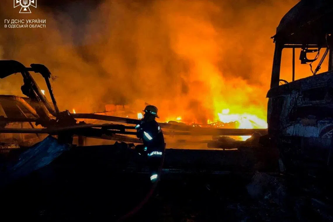 A firefighter works at a site which was hit during Russia's drone attacks in Odesa region.