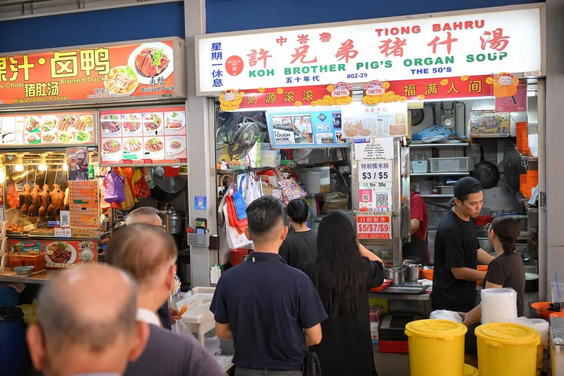 Thomas Koh (right), a third generation hawker at Koh Brothers pig organ soup.