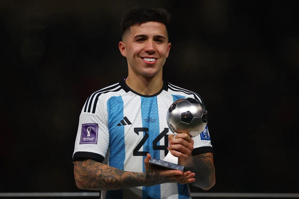 Argentina's Enzo Fernandez is all smiles after being handed the 2022 World Cup's Best Young Player trophy. 