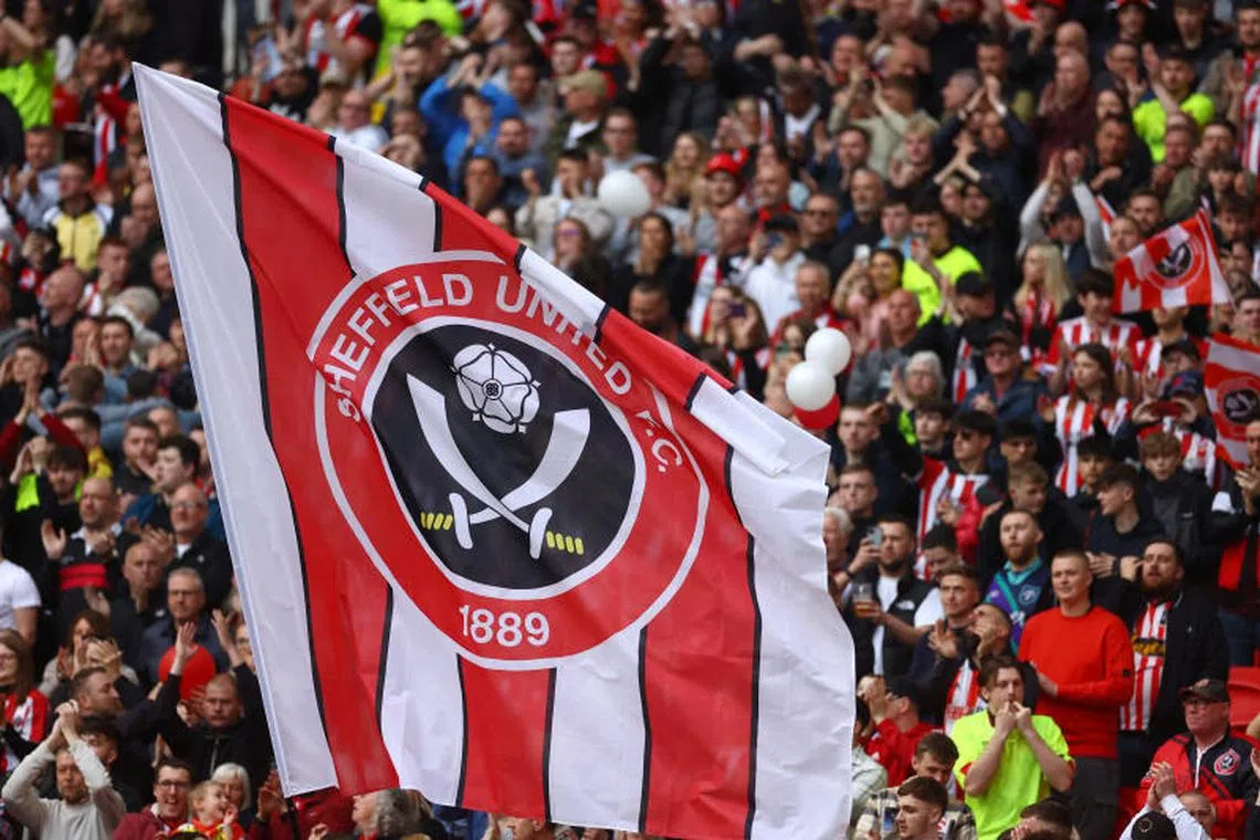 FILE PHOTO: Soccer Football - FA Cup - Semi Final - Manchester City v Sheffield United - Wembley Stadium, London, Britain - April 22, 2023 Sheffield United fans inside the stadium hold up a flag during the match REUTERS/Carl Recine/File Photo