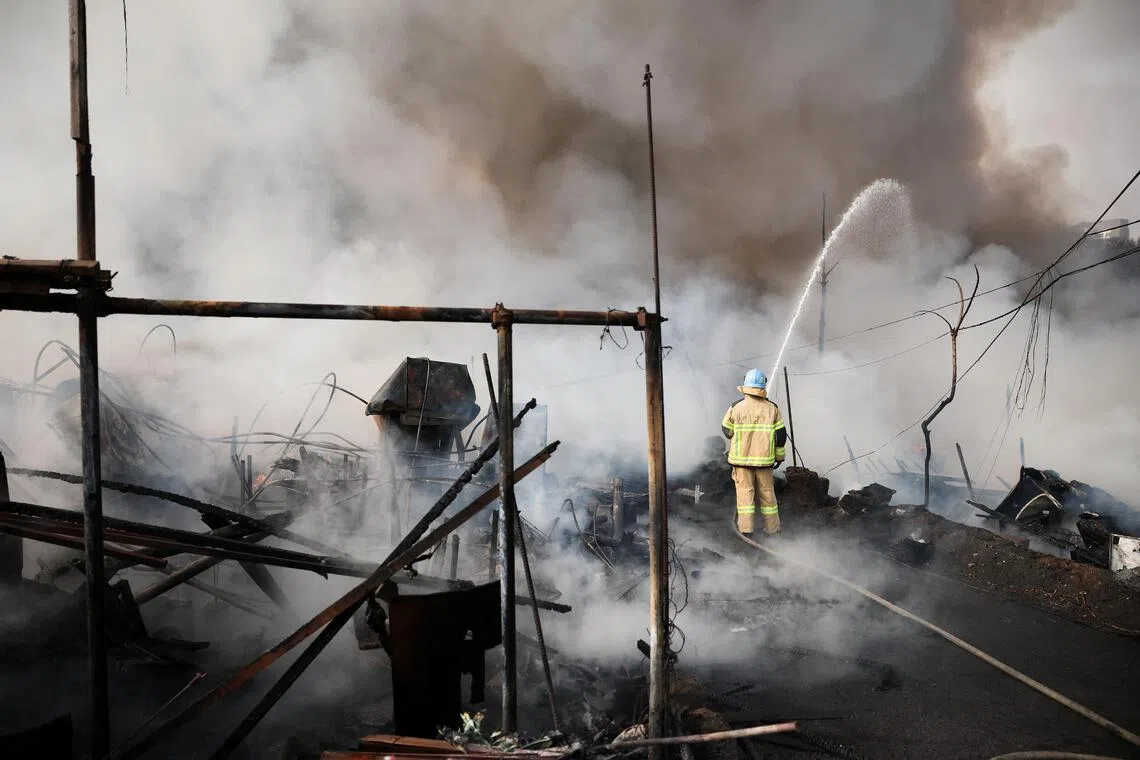 A firefighter works at the scene of a fire at Guryong village, the last shantytown in the Gangnam district, in Seoul, South Korea, January 16, 2026. REUTERS/Kim Hong-ji