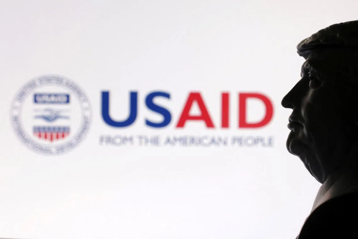 FILE PHOTO: A 3D-printed miniature model of U.S. President Donald Trump with the USAID logo in the background is seen in this illustration taken April 23, 2025. REUTERS/Dado Ruvic/Illustration/File Photo
