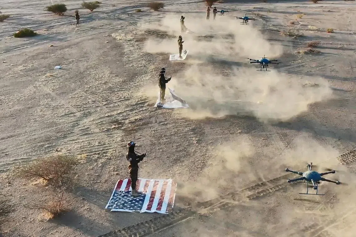 Houthi troopers standing on US and Israeli flags during a military exercise in Yemen on Jan 11, 2024.