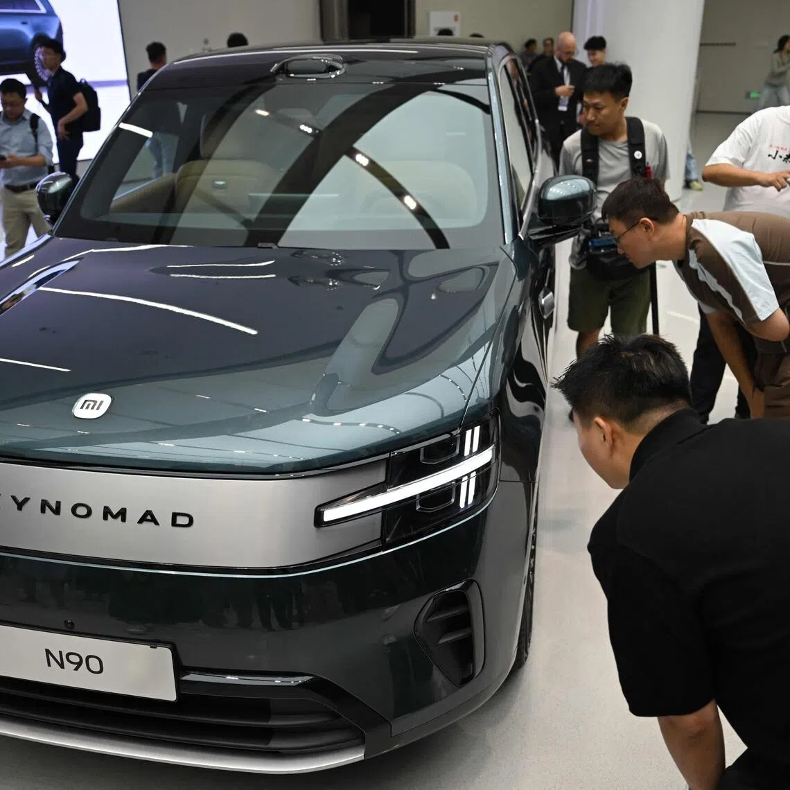 People view the Xiaomi SkyNomad extended range electric vehicle during its launch event in Beijing on July 30.