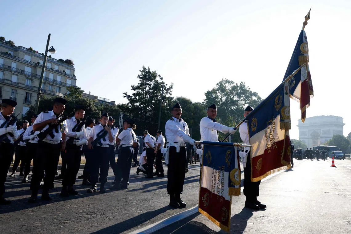 French Air and Space Force personnel prepare before taking part in the Bastille Day military parade along the Avenue Foch in Paris on July 14, 2024. (Photo by Ludovic MARIN / AFP)