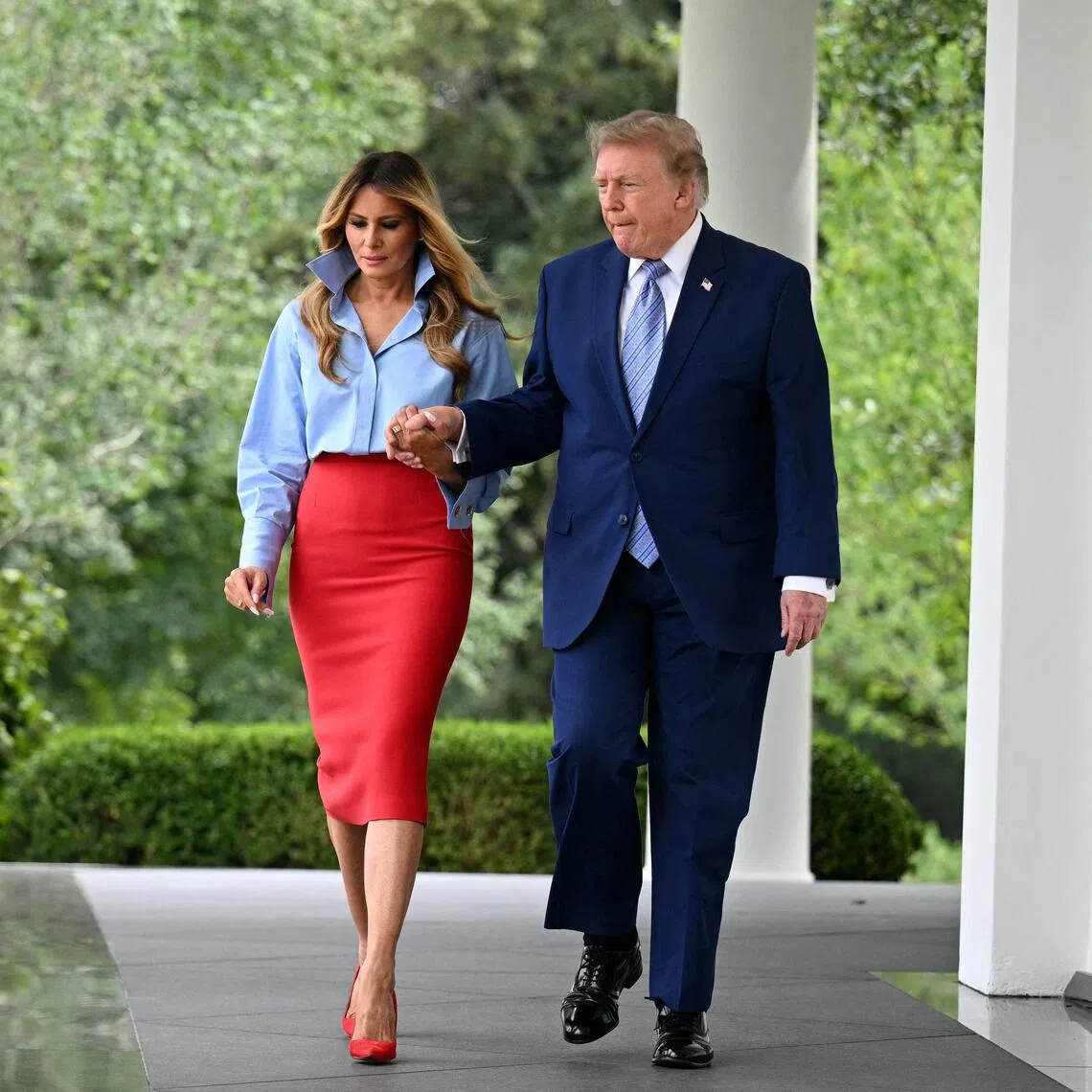 US President Donald Trump and US First Lady Melania Trump held hands as they walked from the Oval Office to the White House Rose Garden.