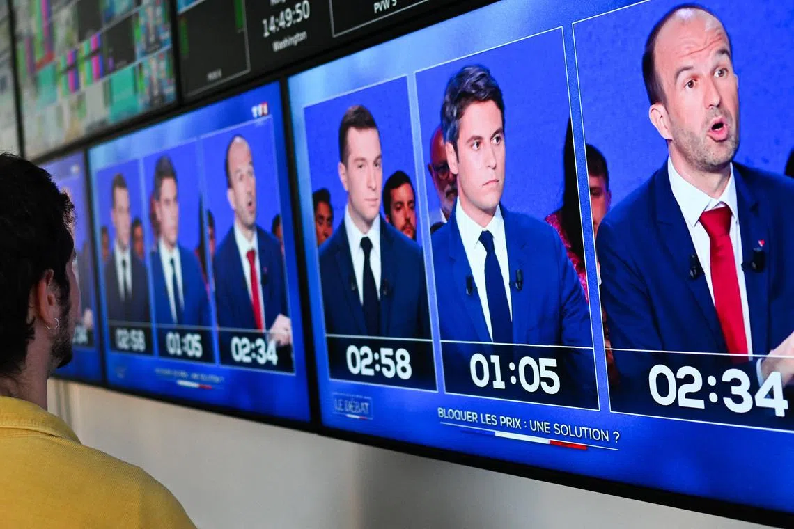 A photograph of monitors in a media control room at AFP headquarters in Paris, displays (From L) French far-right Rassemblement National (RN) party President and lead MEP Jordan Bardella, France's Prime Minister Gabriel Attal and French MP of left wing party La France Insoumise (LFI) Manuel Bompard during a political debate broadcasted on French TV channel TF1, on June 25, 2024, ahead of France's snap elections for a new national assembly on June 30 and July 7, 2024. (Photo by Stefano RELLANDINI / AFP)