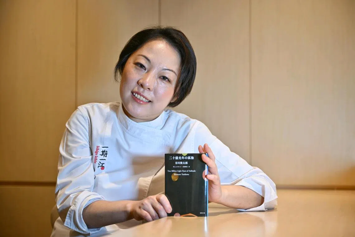 Chef Akane Eno of Ichigo Ichie restaurant, with the book she's reading, Two Billion Light-Years of Solitude by Shuntaro Tanikawa, on Sep 24, 2025.