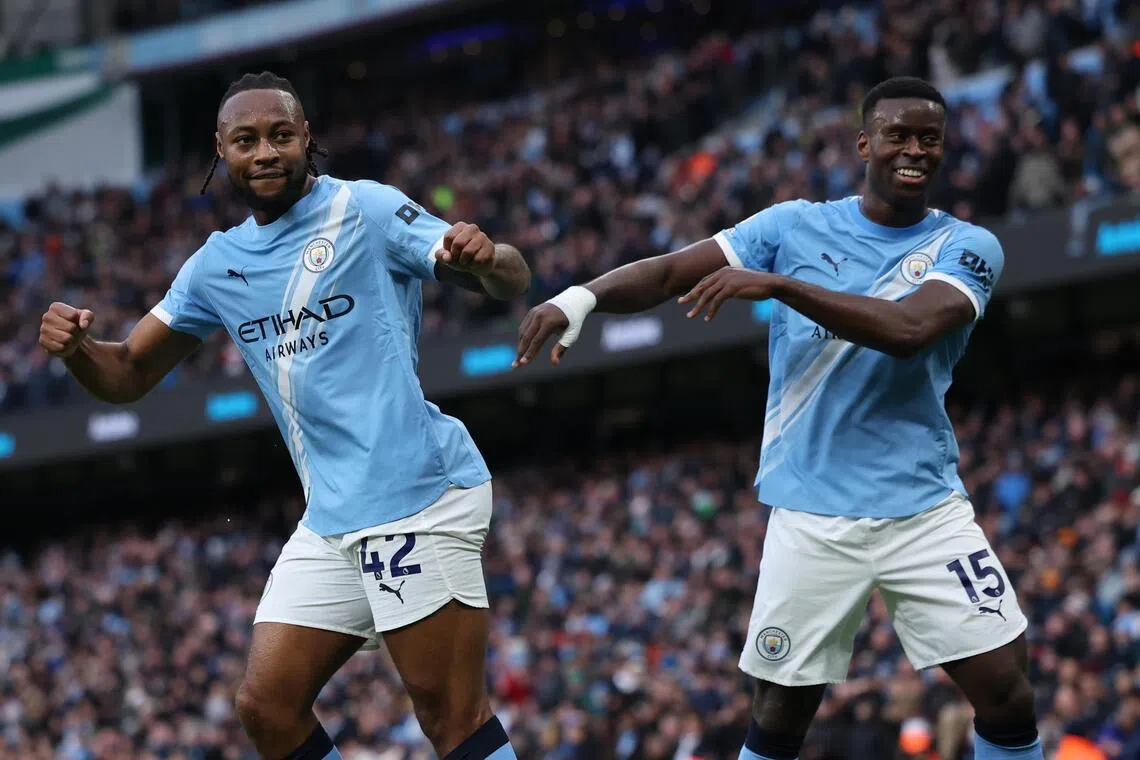 Antoine Semenyo (left) celebrates scoring Manchester City's second goal against Wolves with teammate Marc Guehi.