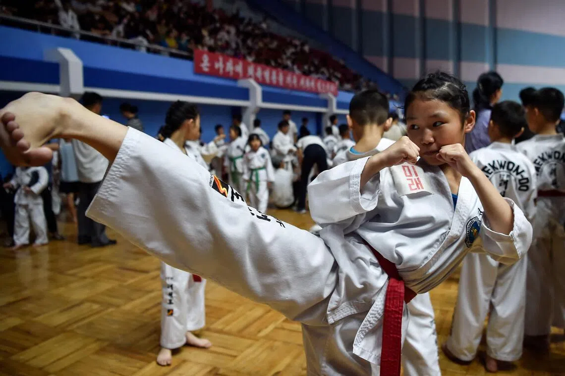 An aspiring athlete practices a kick during the National Taekwon-Do Fans Contest in Pyongyang on Aug 12.