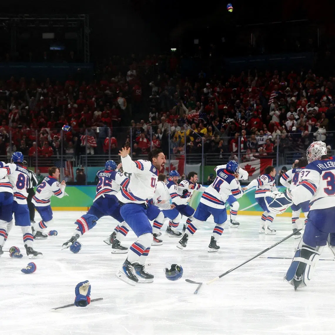Milano Cortina 2026 Olympics - Ice Hockey - Men's Gold Medal Game - Canada vs United States - Milano Santagiulia Ice Hockey Arena, Milan, Italy - February 22, 2026. Connor Hellebuyck of United States and Vincent Trocheck of United States celebrate after Jack Hughes of United States scores their second goal in overtime to win gold. REUTERS/Mike Segar