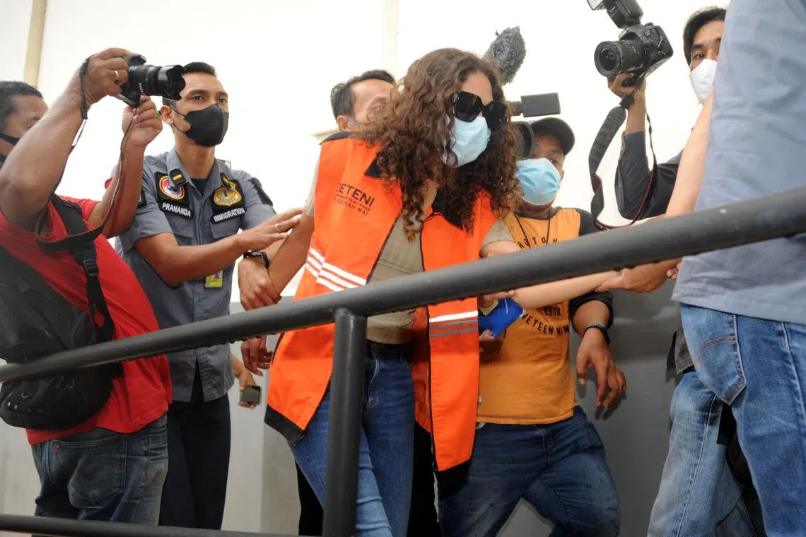 Heather Mack (centre) escorted by Immigration guards to the immigration detention house in Jimbaran, Bali on Oct 29, 2021.