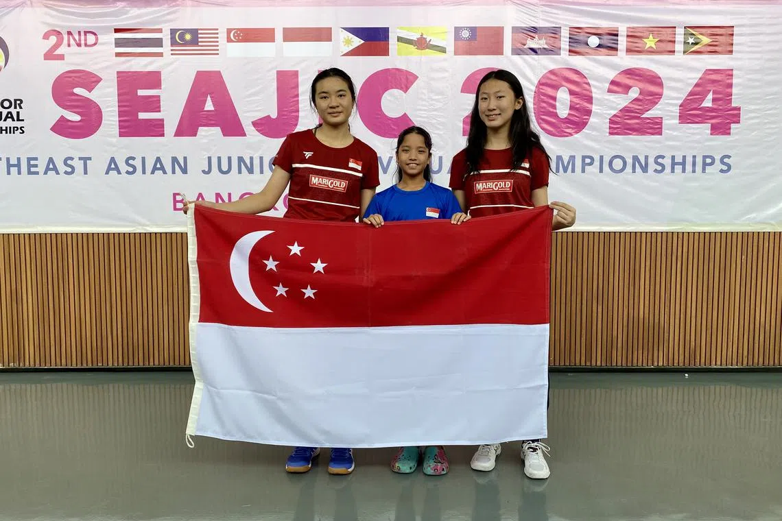 (From left) Singapore squash players Ong Zhe Sim, Kareena Sashikumar and Jacintha Han won their respective events at the South-east Asian Junior Individual Squash Championships.