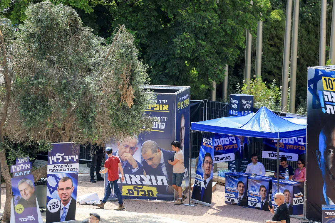 People view stalls and advertisements promoting candidates of the Likud party, led by Israeli Prime Minister Benjamin Netanyahu, on the day of the Likud primaries list vote, ahead of Israel's general election in October, in Jerusalem, August 17, 2026. REUTERS/Ronen Zvulun