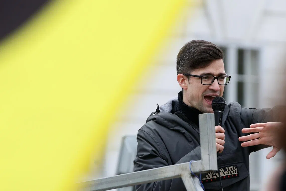 Leader of Austria's Identitarian Movement Martin Sellner speaks during a protest against a police raid at his house, outside the Justice Ministry in Vienna, Austria, April 13, 2019. REUTERS/Lisi Niesner/File Photo