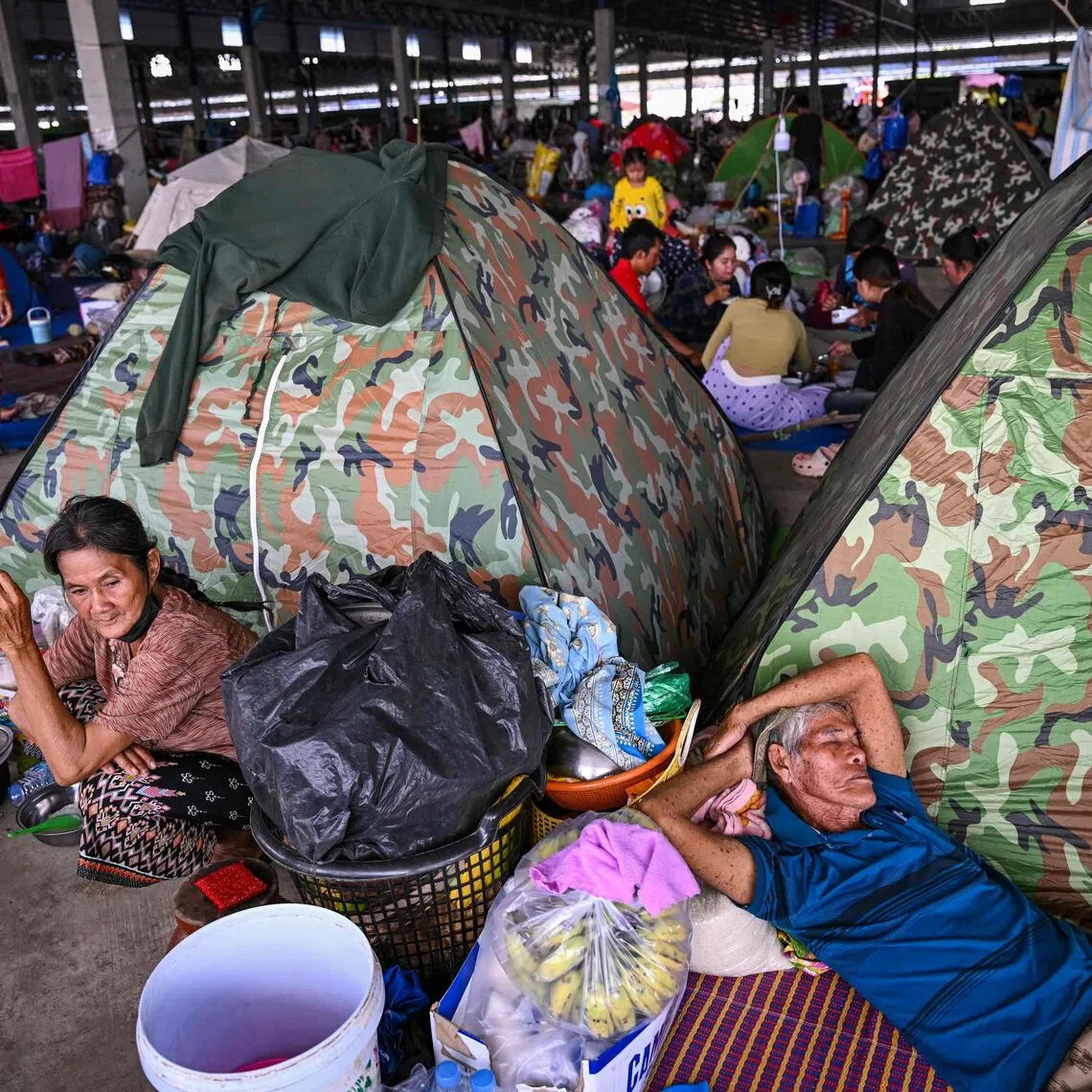 Displaced residents rest at a temporary camp in Cambodia's Banteay Meanchey province on Dec 14, 2025, amid clashes along Cambodia-Thailand border.