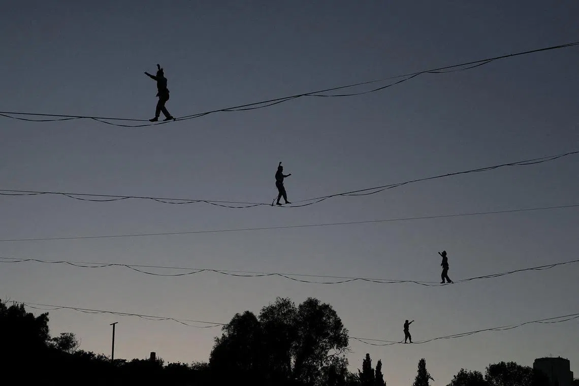 Aerial artists walk high wires suspended across the Hinnom Valley at the dress rehearsal for the opening of the Israel Festival, in Jerusalem, July 27, 2026. REUTERS/Ronen Zvulun TPX IMAGES OF THE DAY