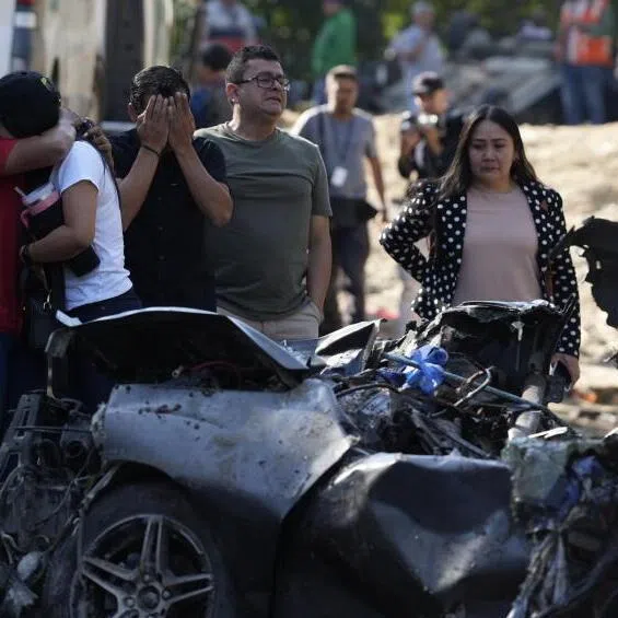 Relatives of the victims at the scene of the attack on the Pan-American Highway in Cajibio, Colombia, on April 26.