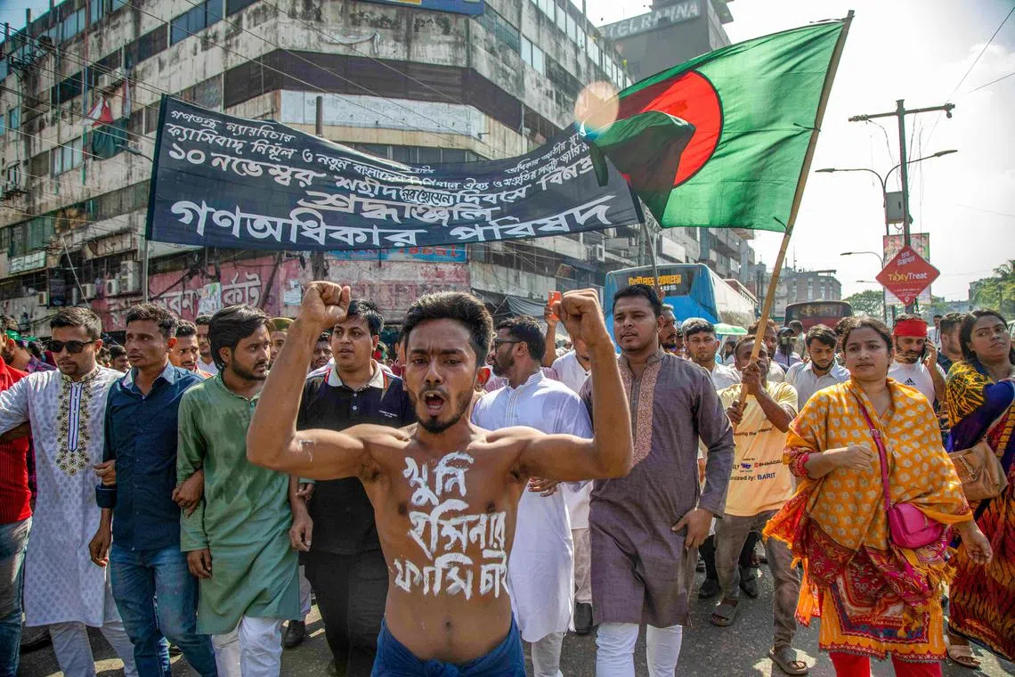Gono Odhikar Parishad party supporters carry Bangladesh's national flag as they protest in Dhaka. 