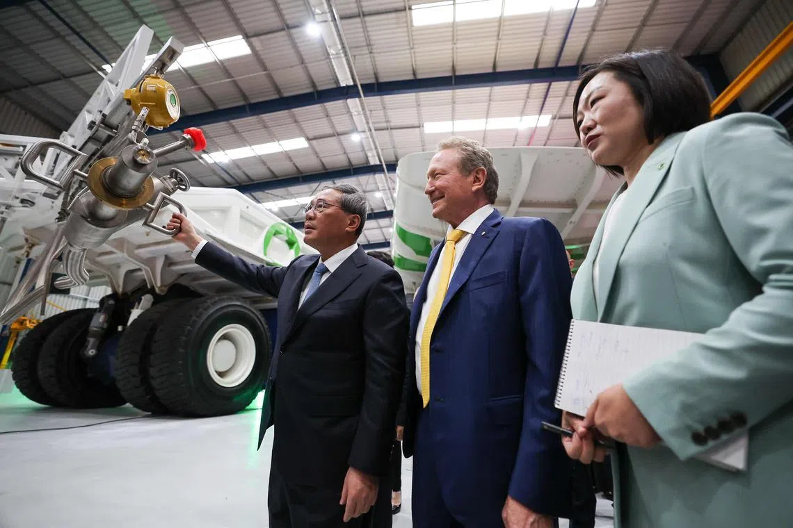 China's Premier Li Qiang inspects a hydrogen refuelling truck as Executive Chairman of Fortescue Andrew Forrest (C) looks on at the Fortescue Hazelmere research and development facility in Hazelmere, a suburb of Perth on June 18, 2024. (Photo by COLIN MURTY / POOL / AFP)