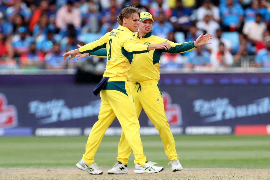 Cricket - ICC Men's Champions Trophy - Semi Final - India v Australia - Dubai International Stadium, Dubai, United Arab Emirates - March 4, 2025 Australia's Cooper Connolly celebrates with Steve Smith after taking the LBW wicket of India's Rohit Sharma REUTERS/Satish Kumar